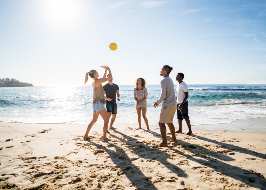 people playing volleyball on beach.