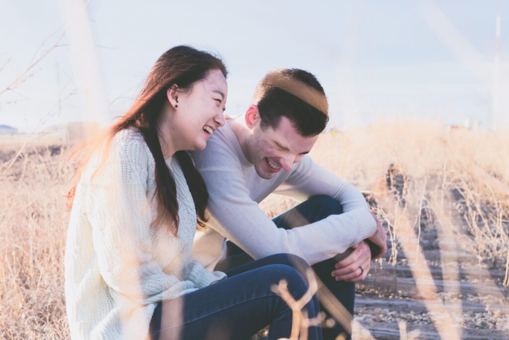 man and women couple sitting on the beach