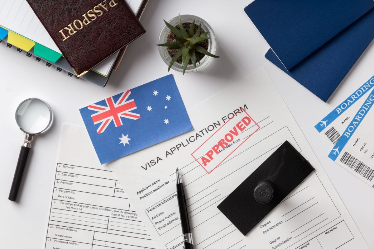 passport laying next to an Australian flag