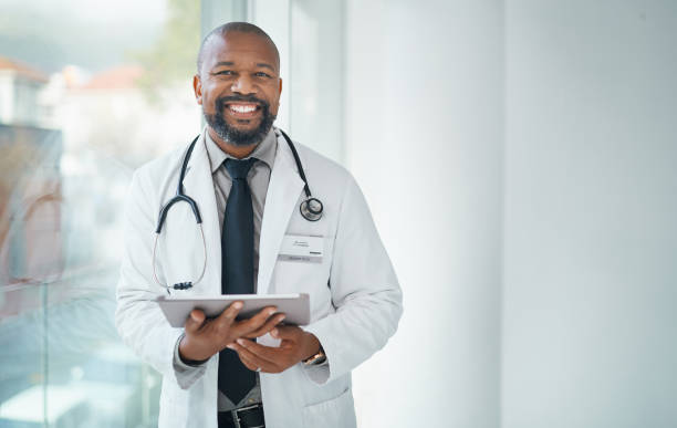 doctor leaning on a window with his clipboard.