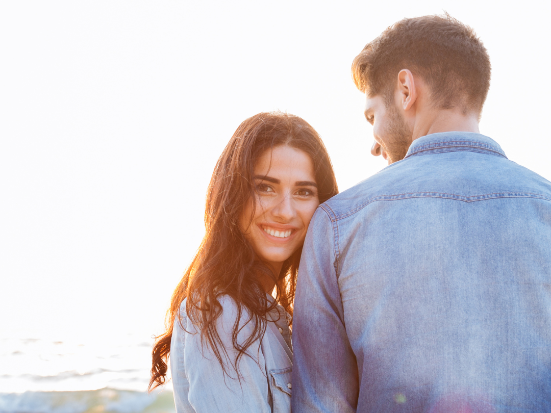 couple walking on the beach holding hands