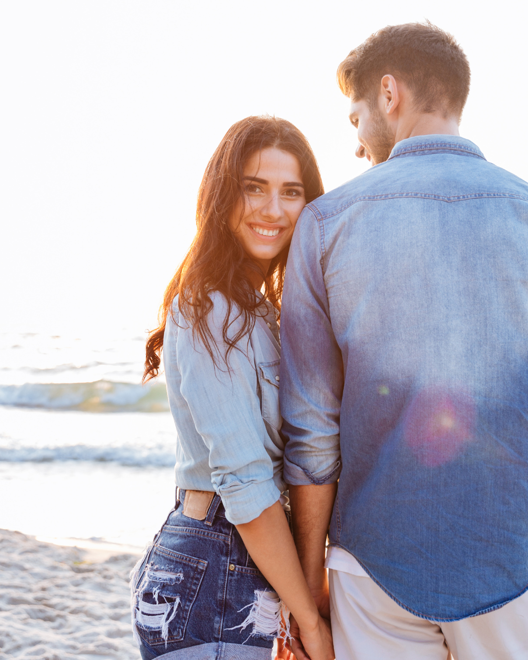 couple walking on the beach holding hands